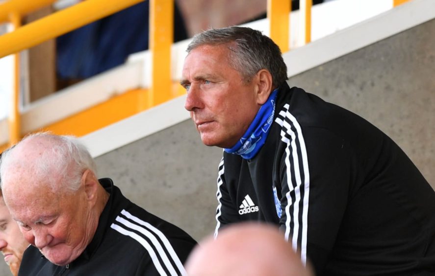 Peterhead manager Jim McInally watches on.