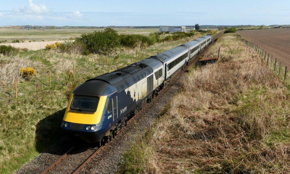 An inter-city ScotRail train travelling through countryside.