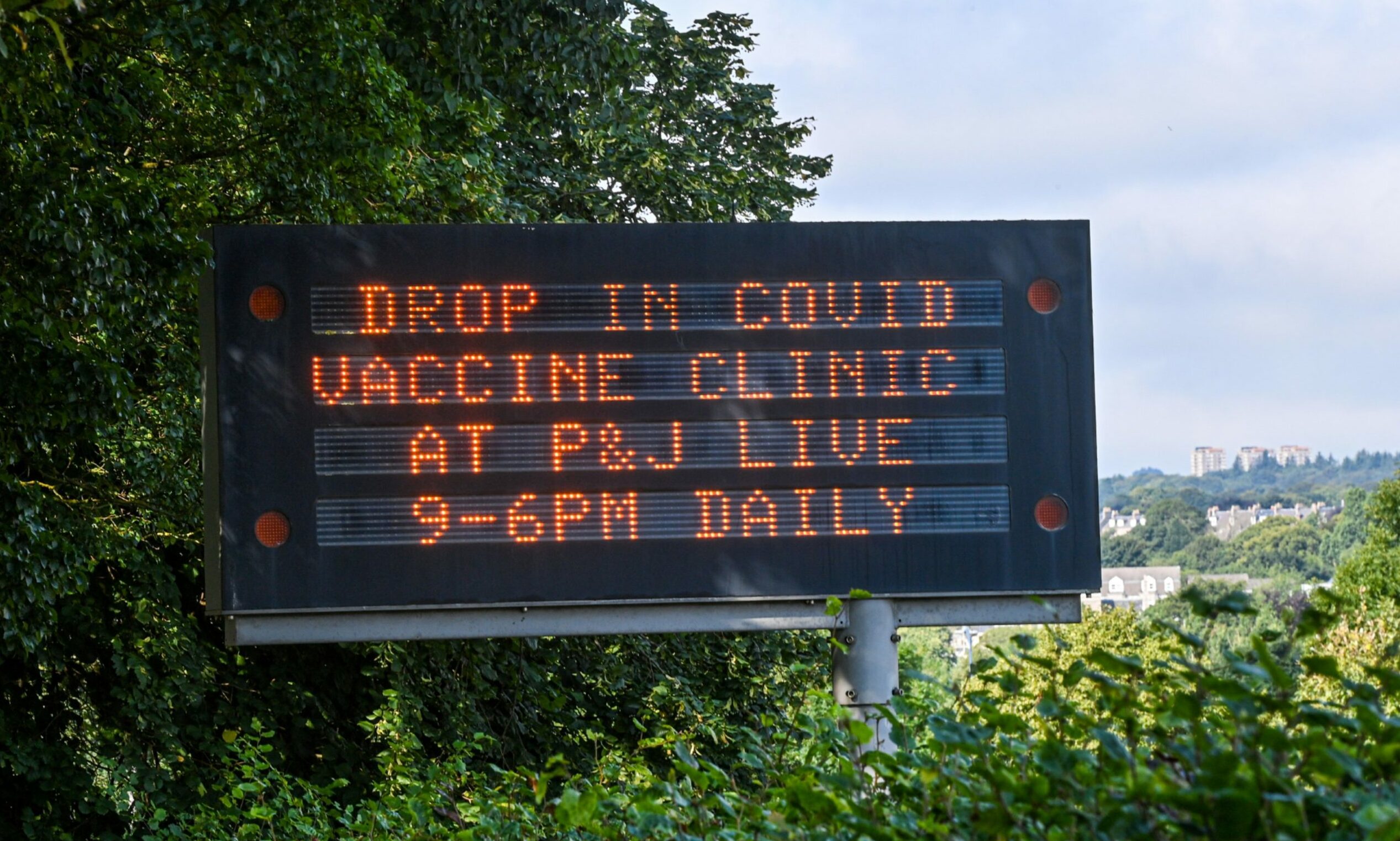 A roadside notice board on West Tullos Road, Aberdeen, displays information about walk-in Covid jab clinics. Picture by Scott Baxter.