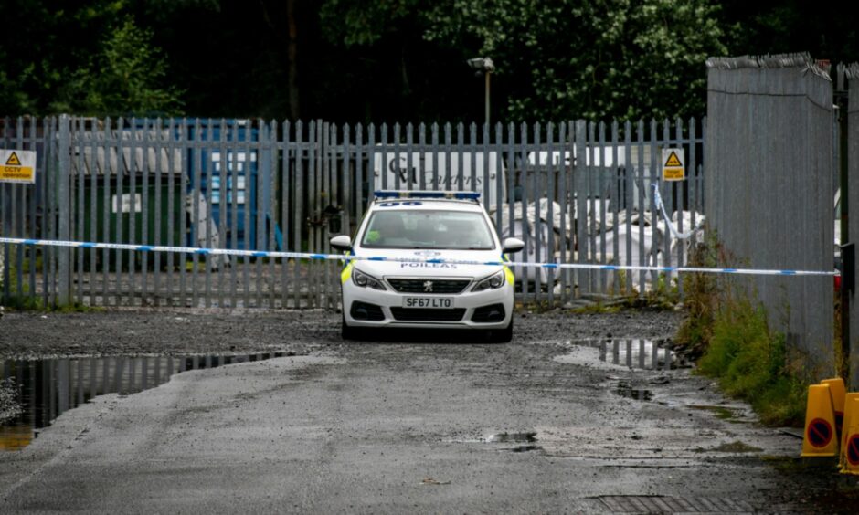 A police car parked near Cable Road close to the area that was cordoned off.