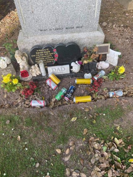 Empty cans of beer were left at the grave during one incident.