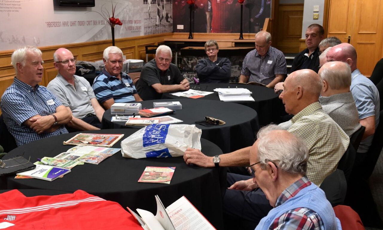 Former player Drew Jarvie talks to members of the football memories group at Pittodrie in August 2019. Picture by Colin Rennie.