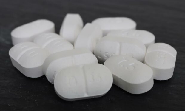 A pile of loose codeine pills, an opiate (derived from opium) used to treat pain.
