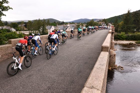 The Tour of Britain peloton as the cross the River Dee in Ballater