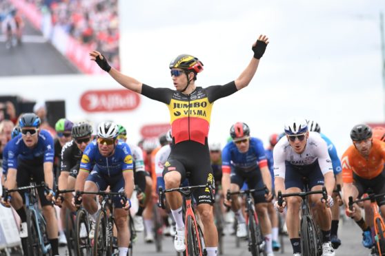 Wout van Aert crosses the line first to win the Tour of Britain.