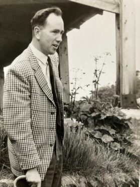 Surrounded by plants, the agriculture professor Andrew Martin as a young man