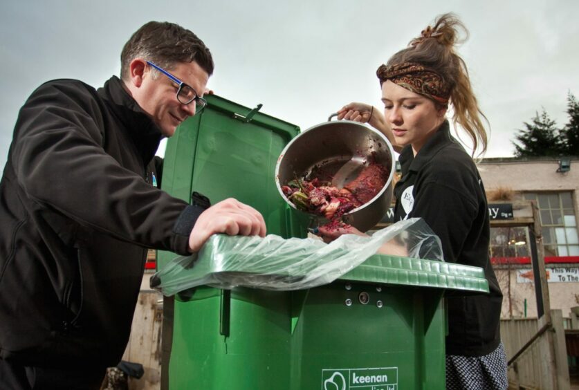 Andrew Gerlach from Keenan Recycling in Aberdeen helps a cafe owner deal with their food waste.