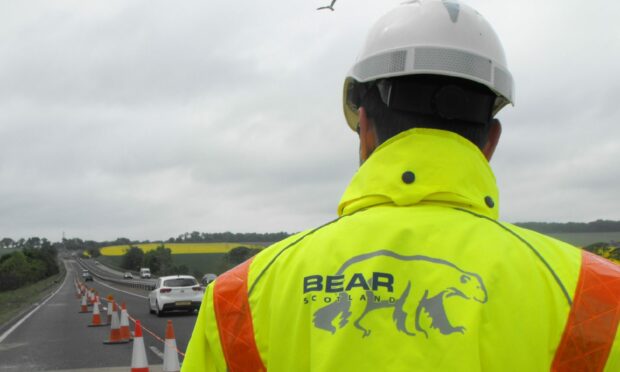 A Bear Scotland worker standing next to a dual carriageway.