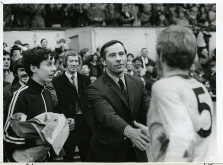 Partick Thistle FC's manager, Davie Parland, congratulates his players on their win.