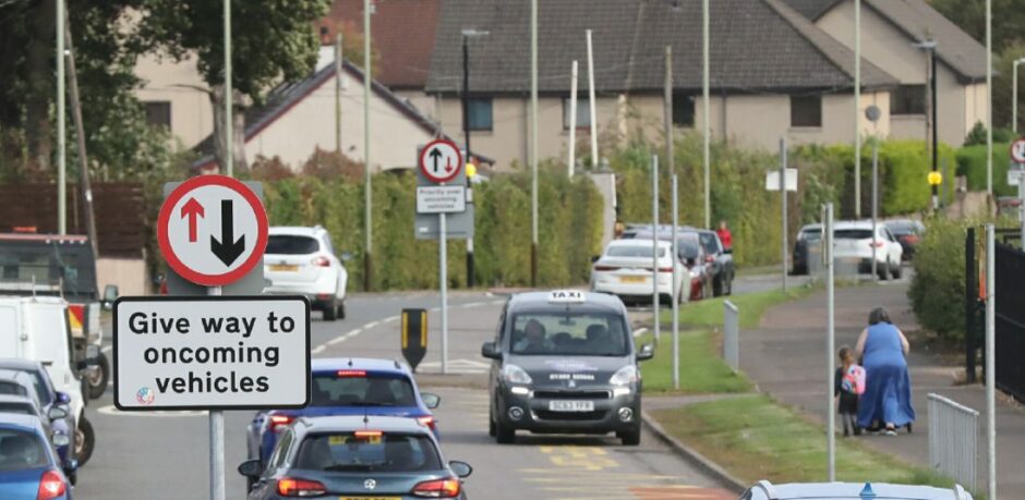 A 'give way' sign used correctly in the foreground, but the sign in the background should be blue.