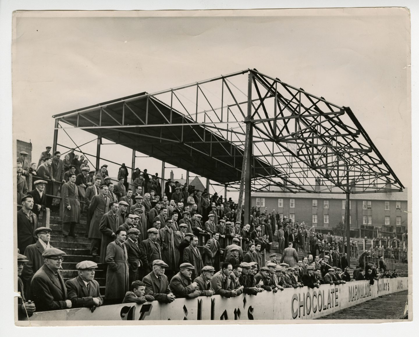 Fans under the new covered enclosure at Tannadice Park in 1957.