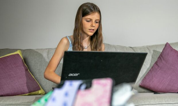Freya Tyson working from a computer with her Justencaseit cases in the foreground.