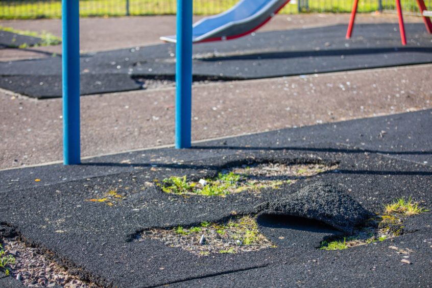 vandals at Broughty Ferry play park - torn up park flooring