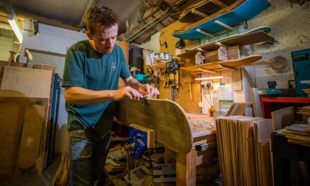 Malcolm Bradley working on a Bonny Company skateboard in his workshop.