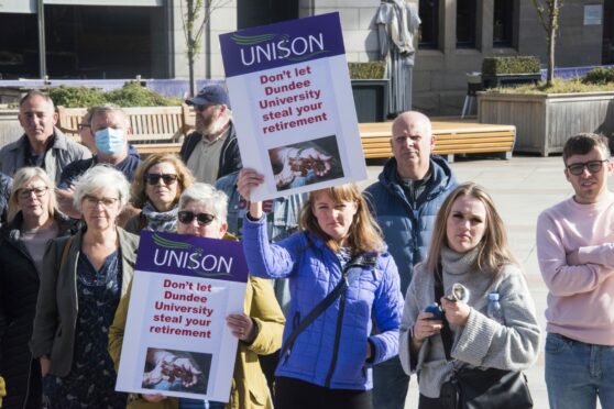 Dundee University workers waving placards during a strike rally in City Square.