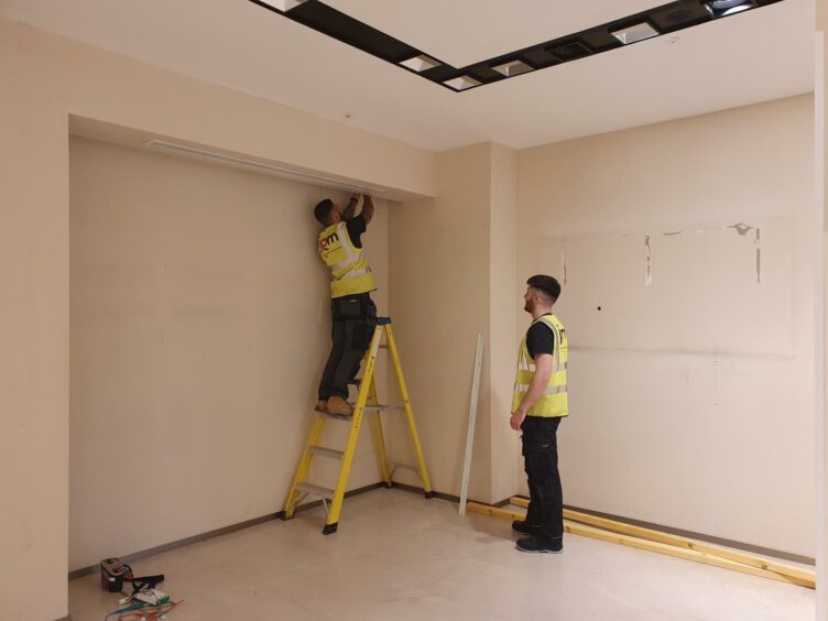 Workers fitting out the former Zara store in Dundee as a Covid vaccination centre