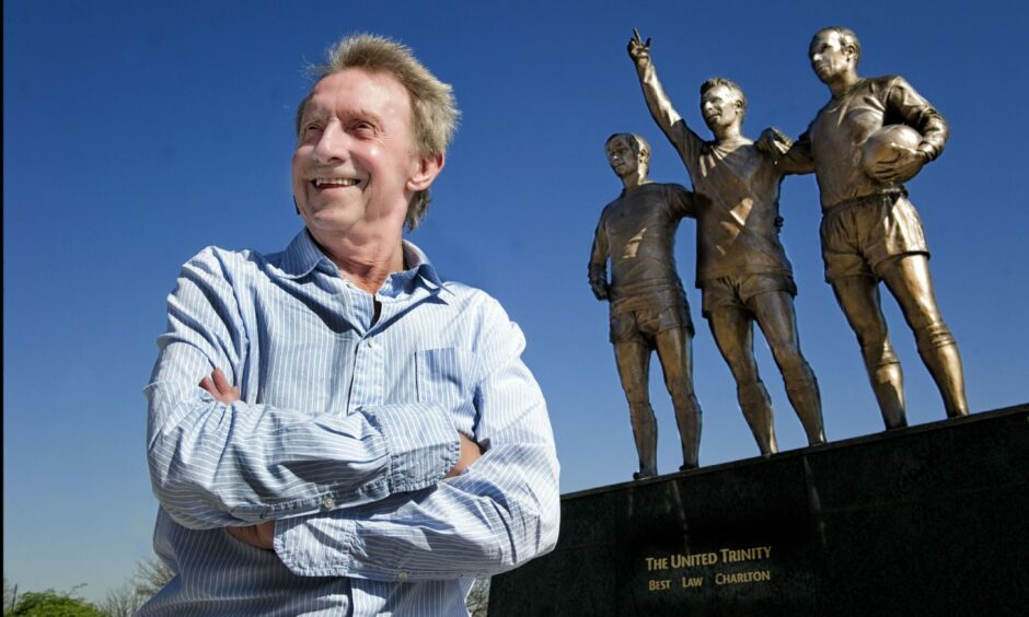 Denis Law, in front of the 'United Trinty' statue outside Old Trafford, which celebrates his time in a Manchester United shirt, along with George Best and Sir Bobby Charlton.