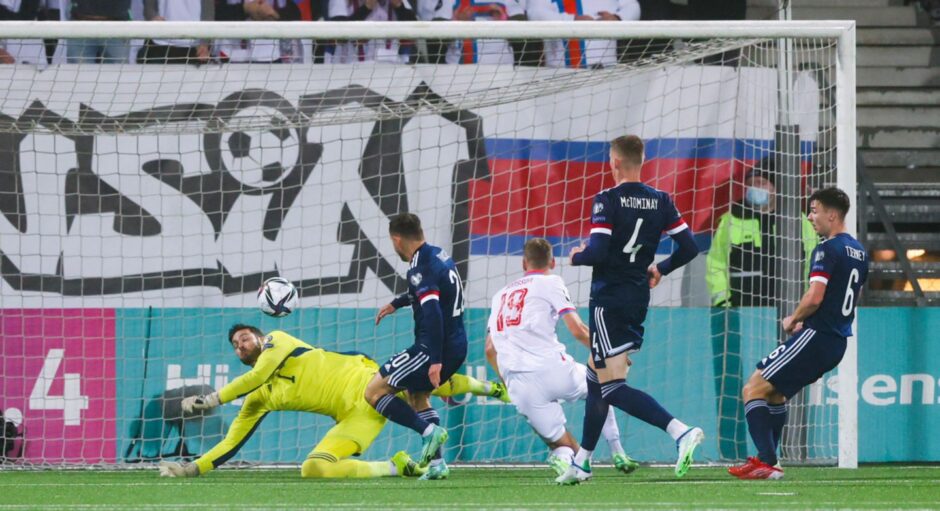 Scotland's Craig Gordon (L) makes a first-half save from the Faroe's Ari Mohr Jonsson.