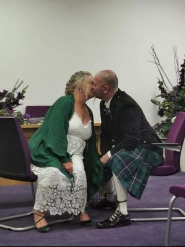 Rhonda and Richard Morton kissing on their wedding day.