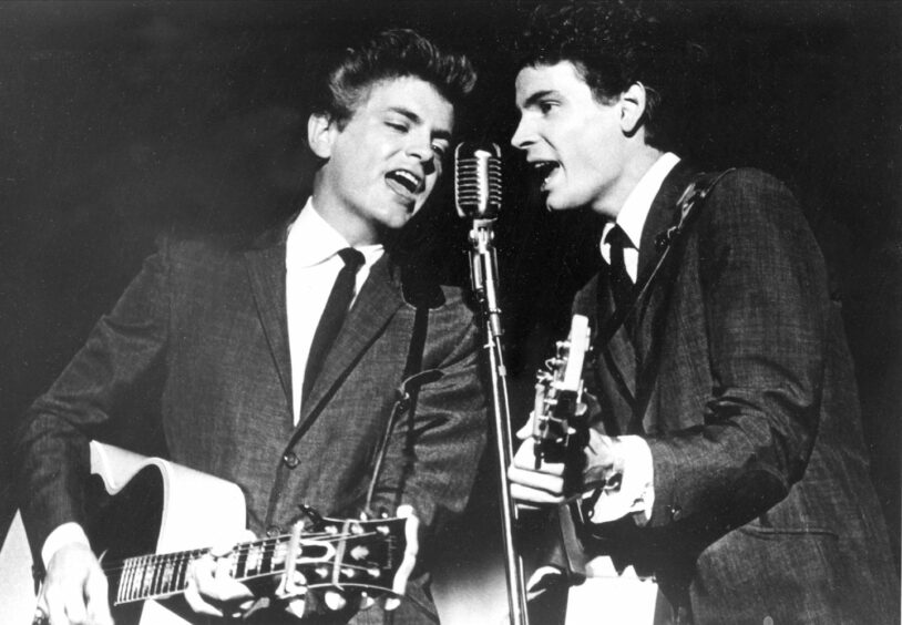 The Everly Brothers, Phil, left, and Don, perform on stage.