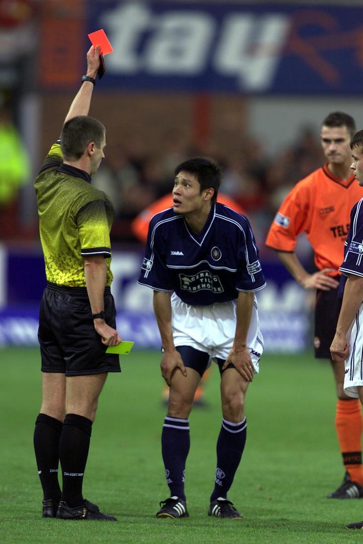 Dundee new boy Fan Zhiyi is sent off by Stuart Dougal.