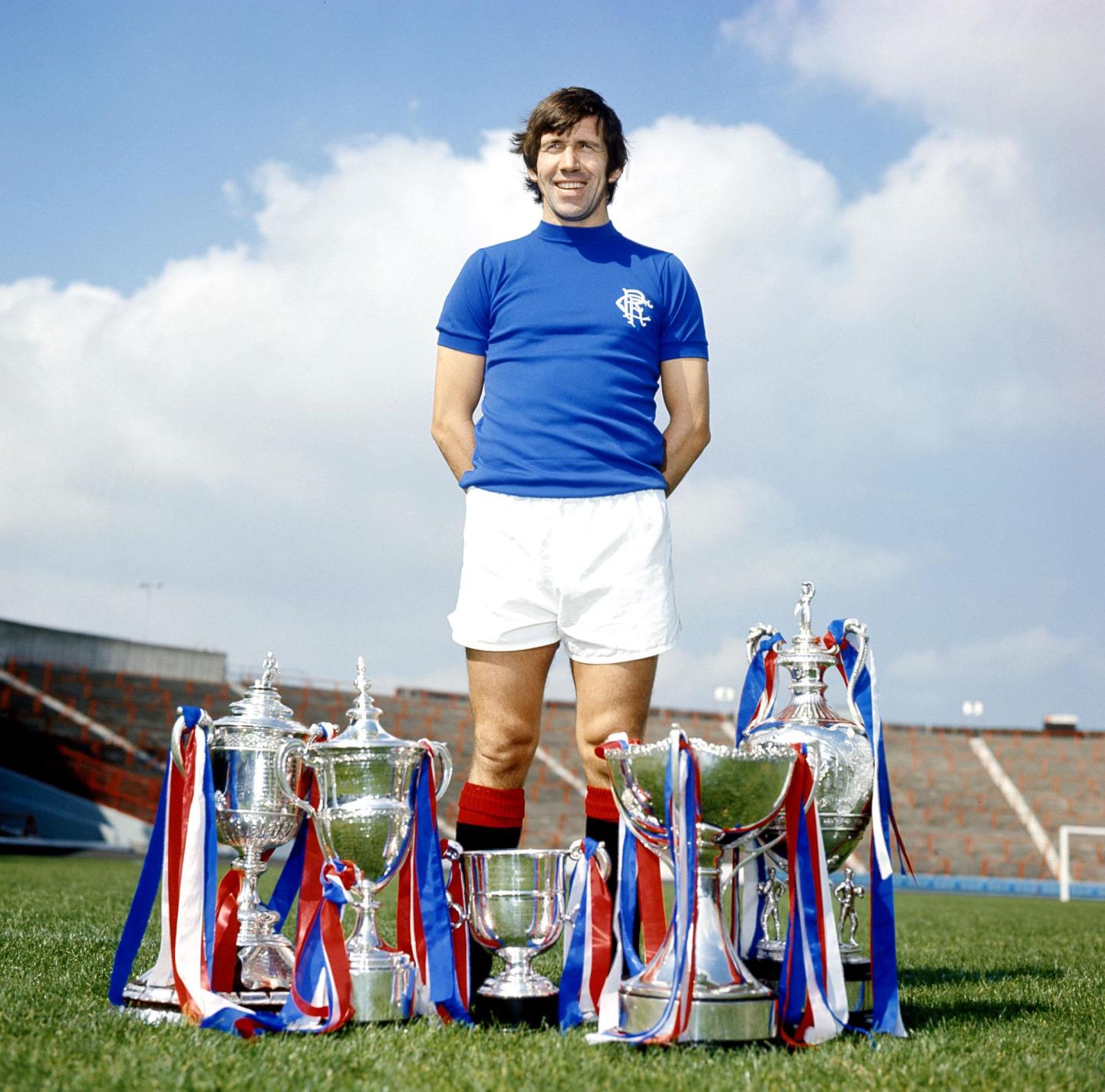 Rangers legend John Greig shows off his side's trophy haul at the beginning of the 1976-77 season.