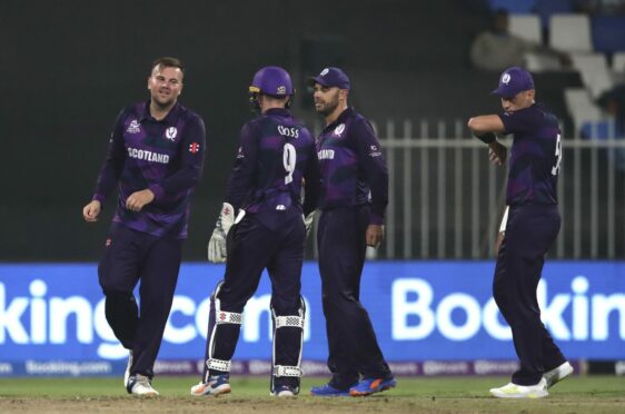 Scotland bowler Mark Watt, left, celebrates the dismissal of Afghanistan's Hazratullah Zazai.