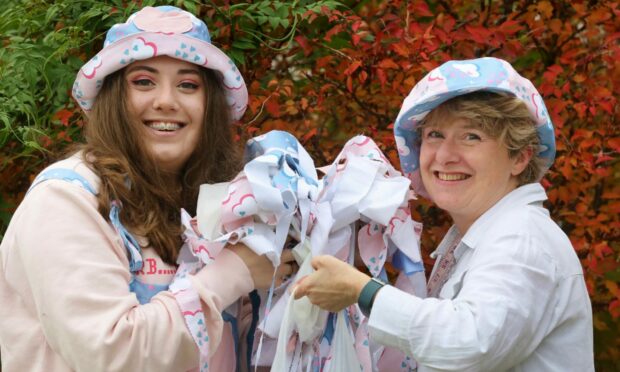 Megan and Liz Laing wearing and showing off blue and pink Dilly Dream clothing.