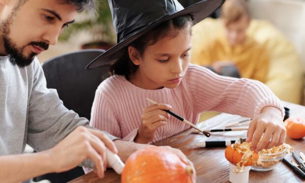 Parent and child doing Halloween activities