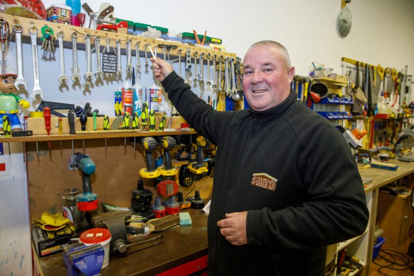 Community champion Bob McPhail enjoys helping in the workshop at the community shed.