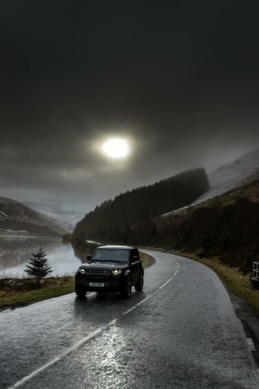 Land Rover Defender V8 with mountains in the background