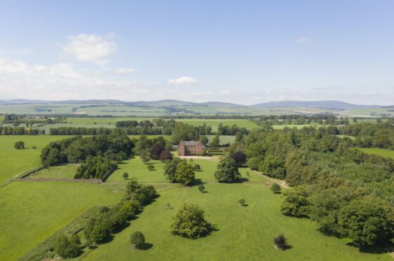 Aerial view of Careston Castle set in a large expanse of green countryside and woodland.