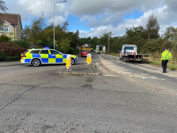 A police car, fire engine and ambulance on the B9149 in Lochgelly after a crash