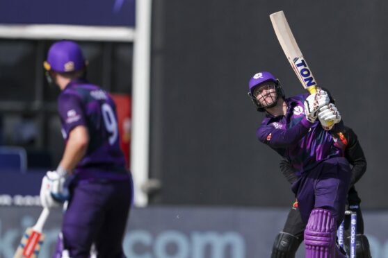 Scotland batter Richie Berrington hits the ball for six.