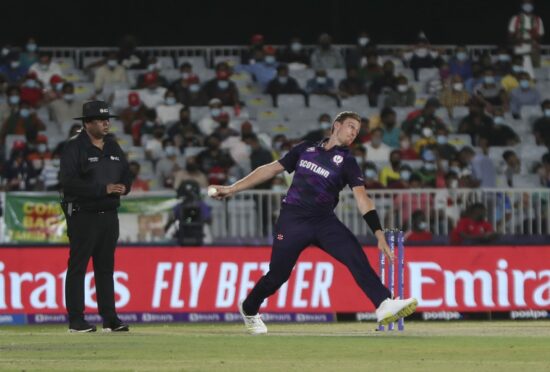 Scotland bowler Brad Wheal in action against Oman.