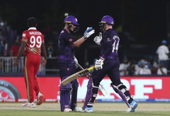 Scotland batters Matthew Cross and Richie Berrington celebrate after seeing their side to victory over Oman.