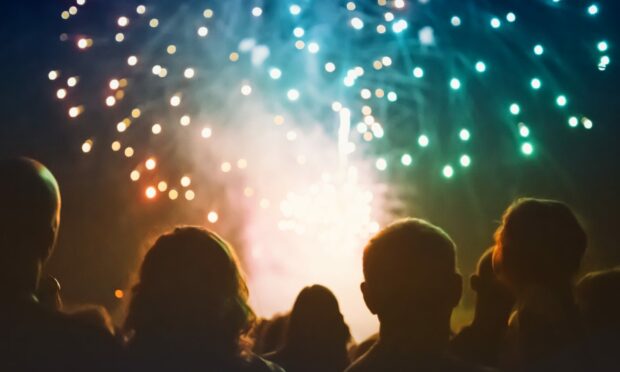 Crowd watching fireworks and celebrating