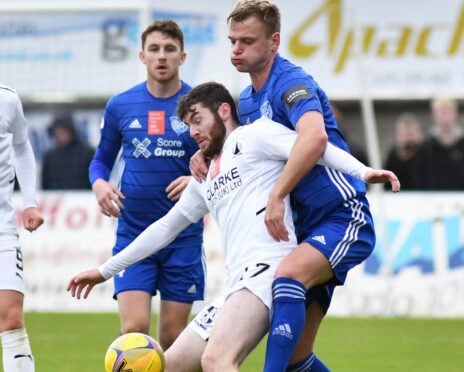 Peterhead defender Jason Brown tangles with Falkirk's Aidan Keena.