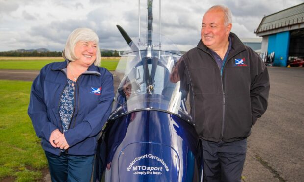 Elaine and Kevin Whitehead from Alba Airsports standing by a gyrocopter.