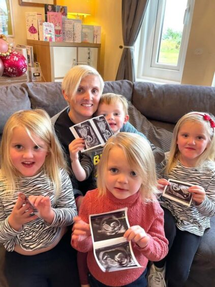 Members of the Sullivan family with scans of the new baby
