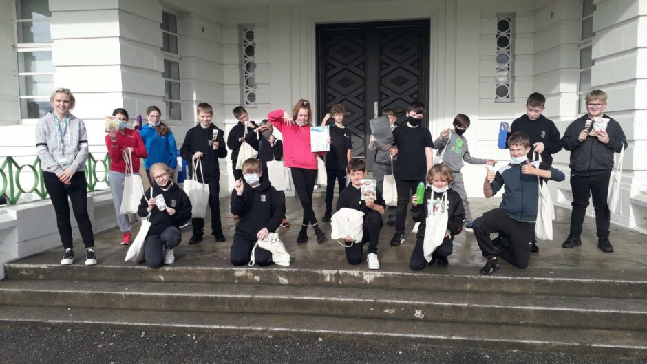 Inverness pupils show off their new water bottles, colouring books and other goodies from the High Life Highland mental health wellbeing packs.