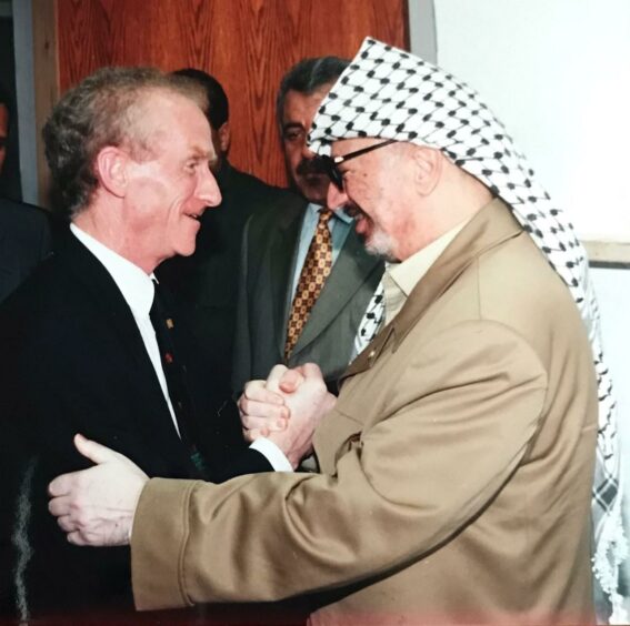 Meeting Palestinian leader Yasser Arafat with whom Ernie had a long-standing friendship as part of his ongoing support of the Palestinian people.