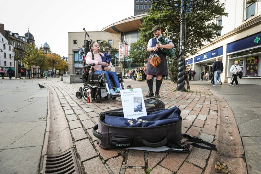 Katie Robertson and Liam Eaton, pipe sergeant with the Dundee City Pipe Band who busk together regularly.