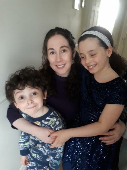 Sarah O'Connell, the Long Covid Kids representative for Ireland, smiles for a photo with her son Jake and daughter Hayley.