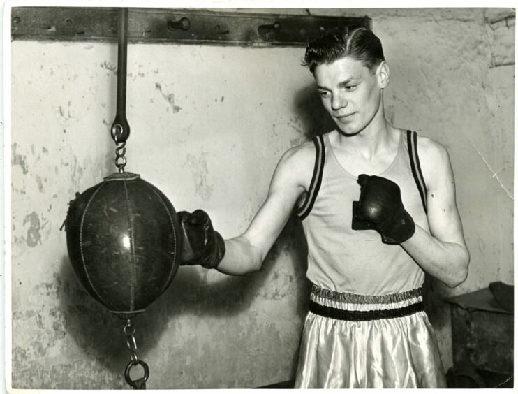 Dick McTaggart goes through a training routine in 1954.