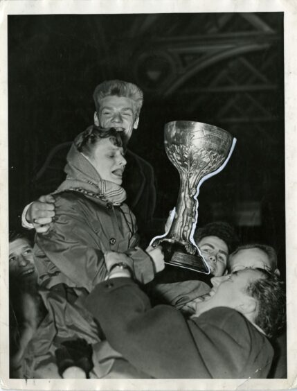 Dick McTaggart with sister Anne at the station as he returns home to Dundee after his triumph.