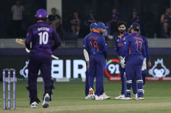 India's Ravindra Jadeja, without cap, celebrates with teammates the dismissal of Scotland all-rounder Michael Leask