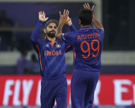 India's captain Virat Kohli congratulates Ravichandran Ashwin after dismissing Scotland all-rounder Chris Greaves