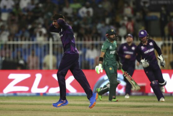 Scotland spinner Hamza Tahir, left, celebrates the dismissal of Pakistan's Mohammad Rizwan.