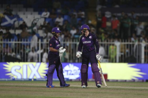 Scotland batter Richie Berrington, right, celebrates with partner Chris Greaves after hitting a six against Pakistan